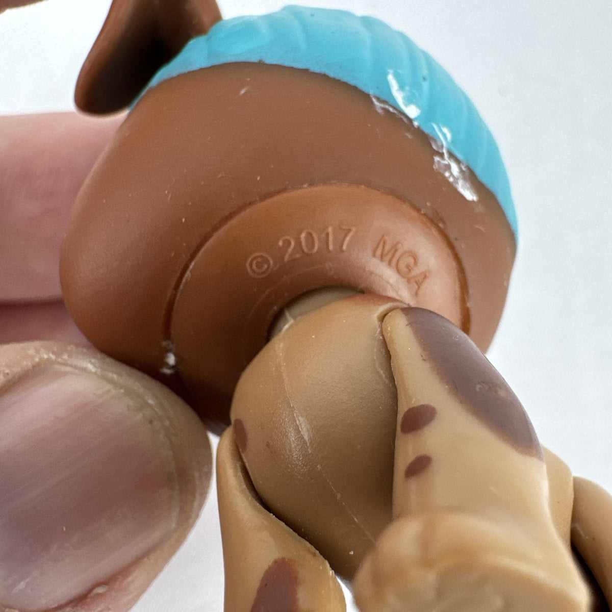 MGA L.O.L. Surprise! Pets brown puppy figure with teal blue hair and purple eyes