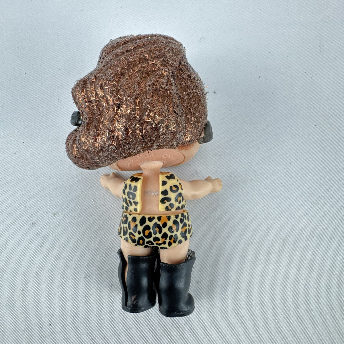 MGA L.O.L. Surprise! 3-inch doll wearing leopard print outfit, cat-eye sunglasses, and boots with brown glitter hair
