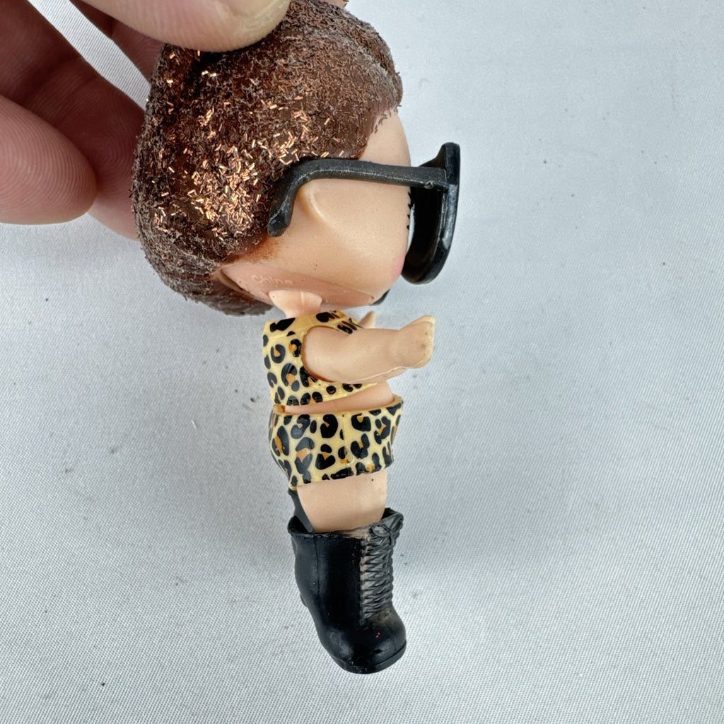 MGA L.O.L. Surprise! 3-inch doll wearing leopard print outfit, cat-eye sunglasses, and boots with brown glitter hair