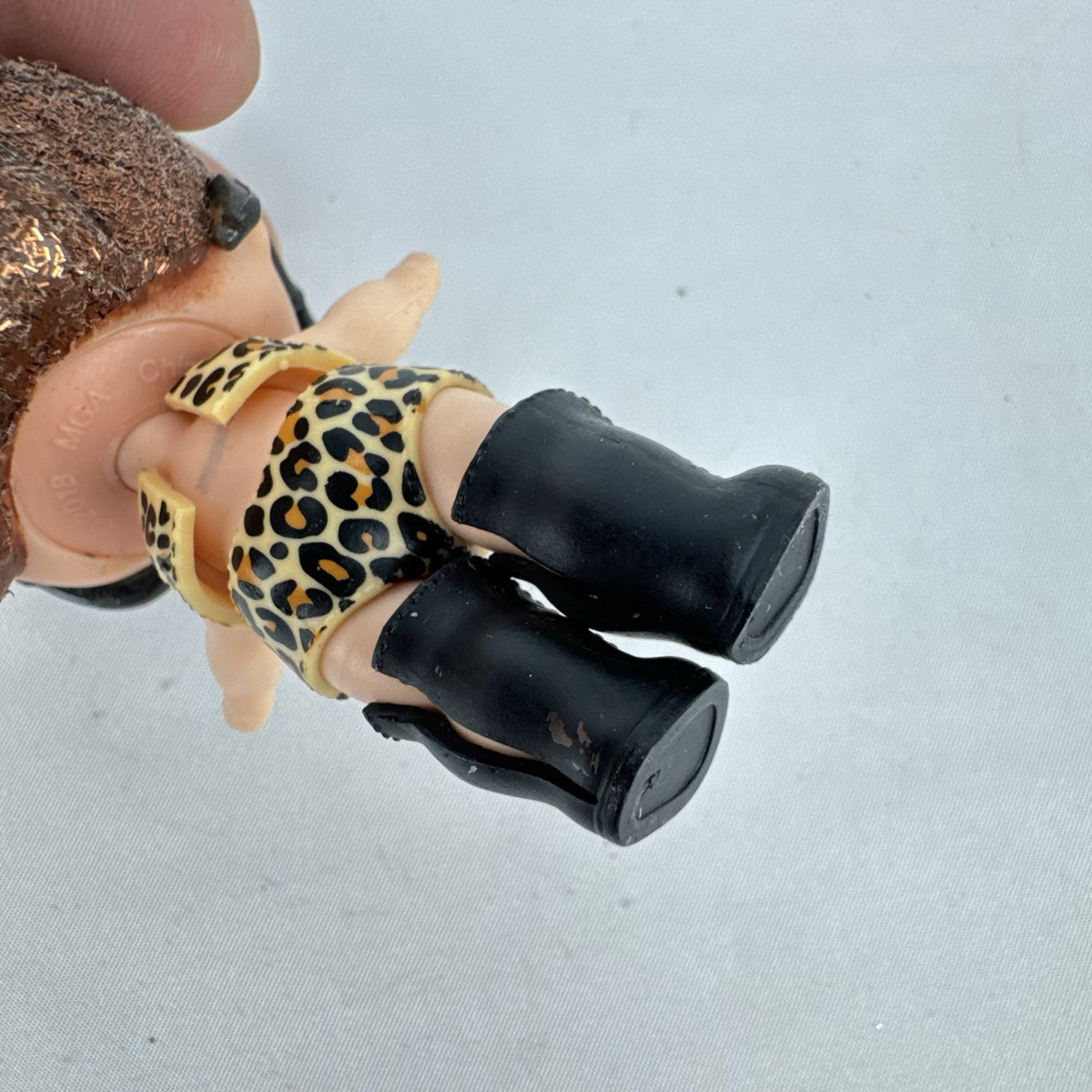 MGA L.O.L. Surprise! 3-inch doll wearing leopard print outfit, cat-eye sunglasses, and boots with brown glitter hair