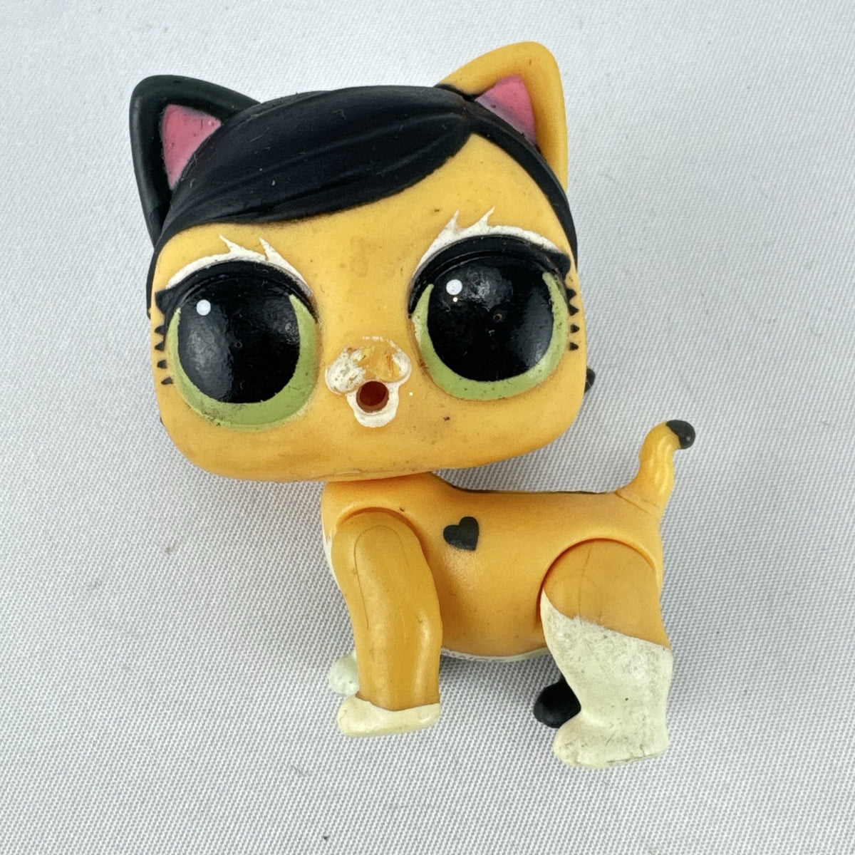 MGA L.O.L. Surprise! Pets 2-inch calico cat vinyl figure with black braided pigtails and green eyes