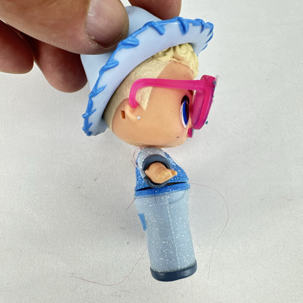 MGA L.O.L. Surprise! Boys Series 1 Do-Si-Dude 3-inch doll wearing blue cowboy hat and pink sunglasses