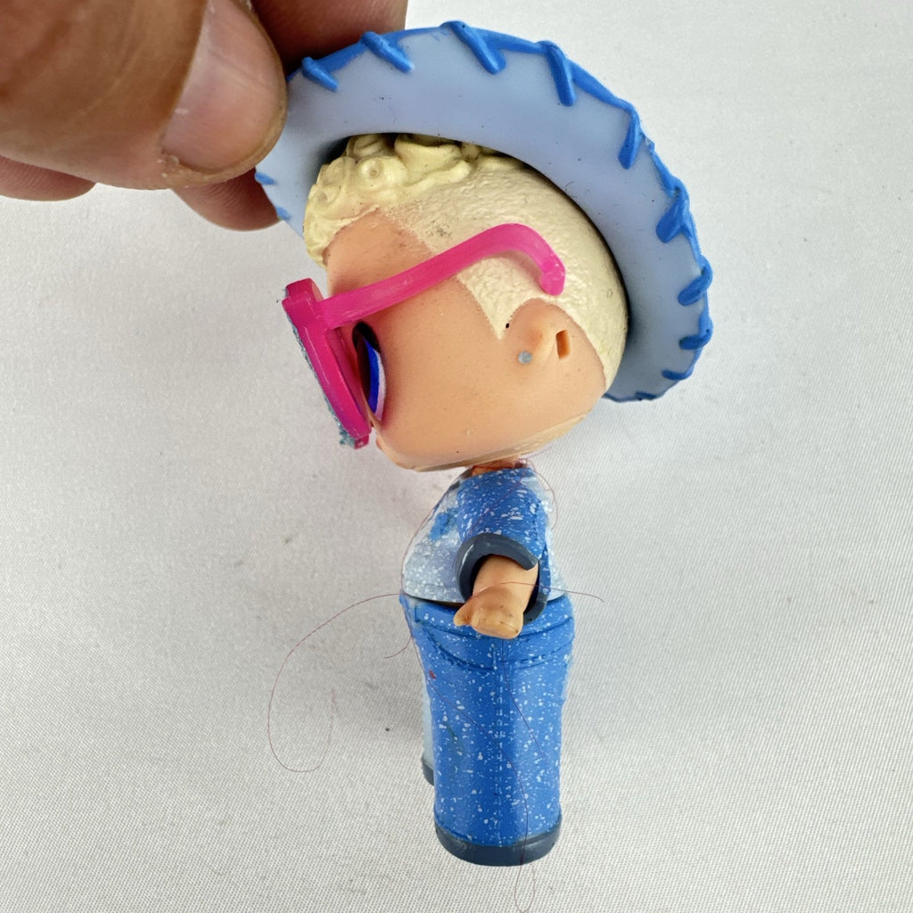 MGA L.O.L. Surprise! Boys Series 1 Do-Si-Dude 3-inch doll wearing blue cowboy hat and pink sunglasses
