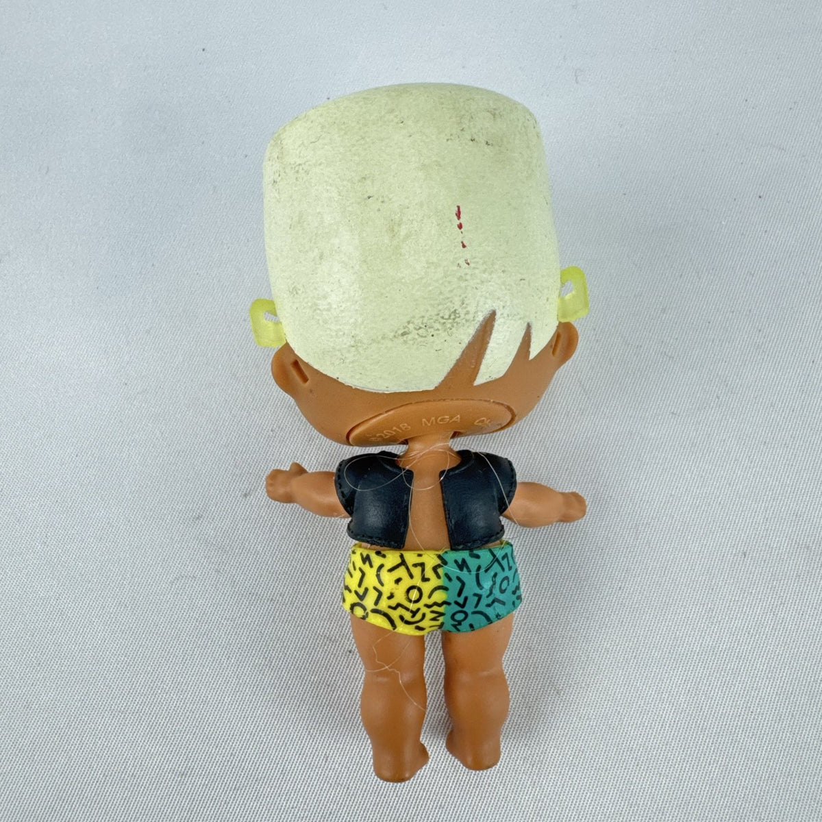 MGA Entertainment L.O.L. Surprise! 3-inch mini doll with blonde flat-top hair, sunglasses, and BAD crop top