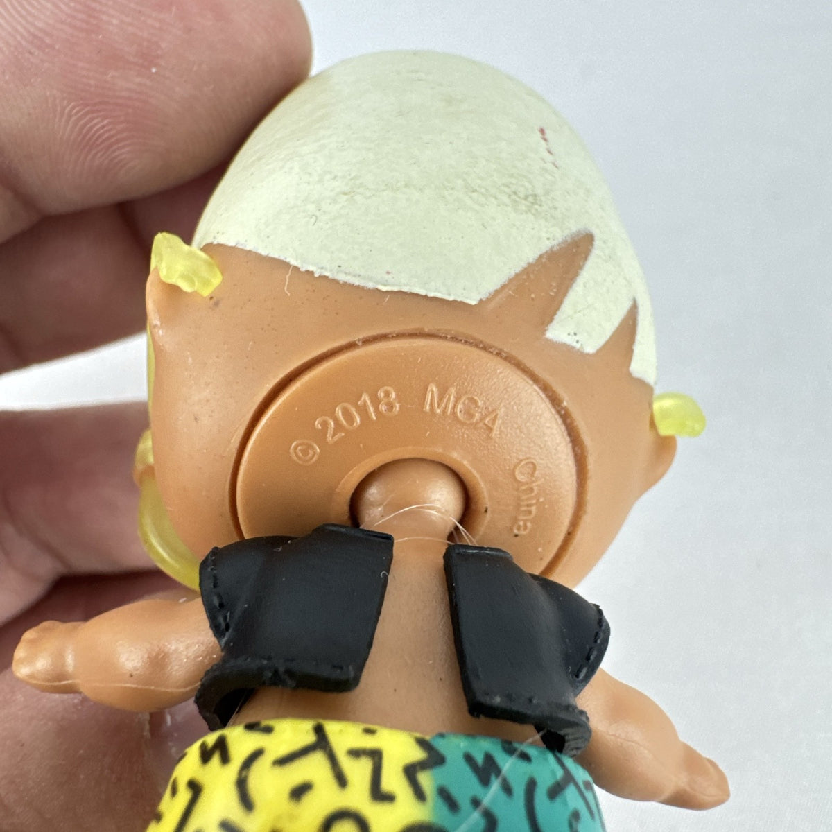 MGA Entertainment L.O.L. Surprise! 3-inch mini doll with blonde flat-top hair, sunglasses, and BAD crop top