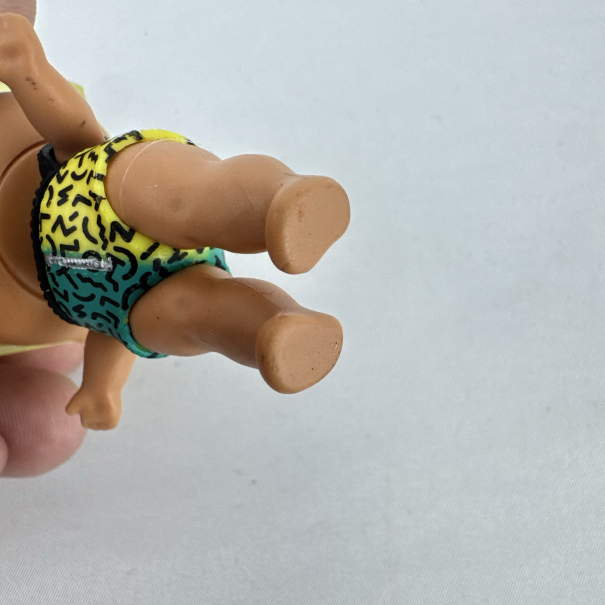 MGA Entertainment L.O.L. Surprise! 3-inch mini doll with blonde flat-top hair, sunglasses, and BAD crop top