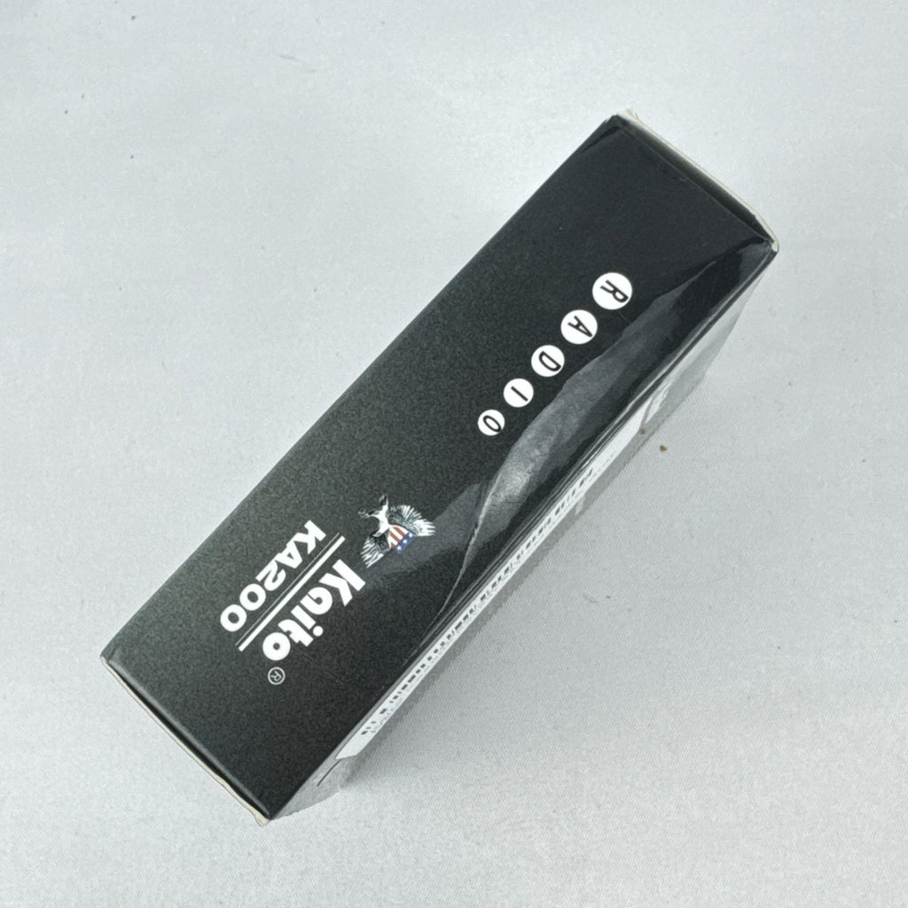 Gray Kaito KA200 pocket AM FM radio with analog dial and headphone jack in original packaging