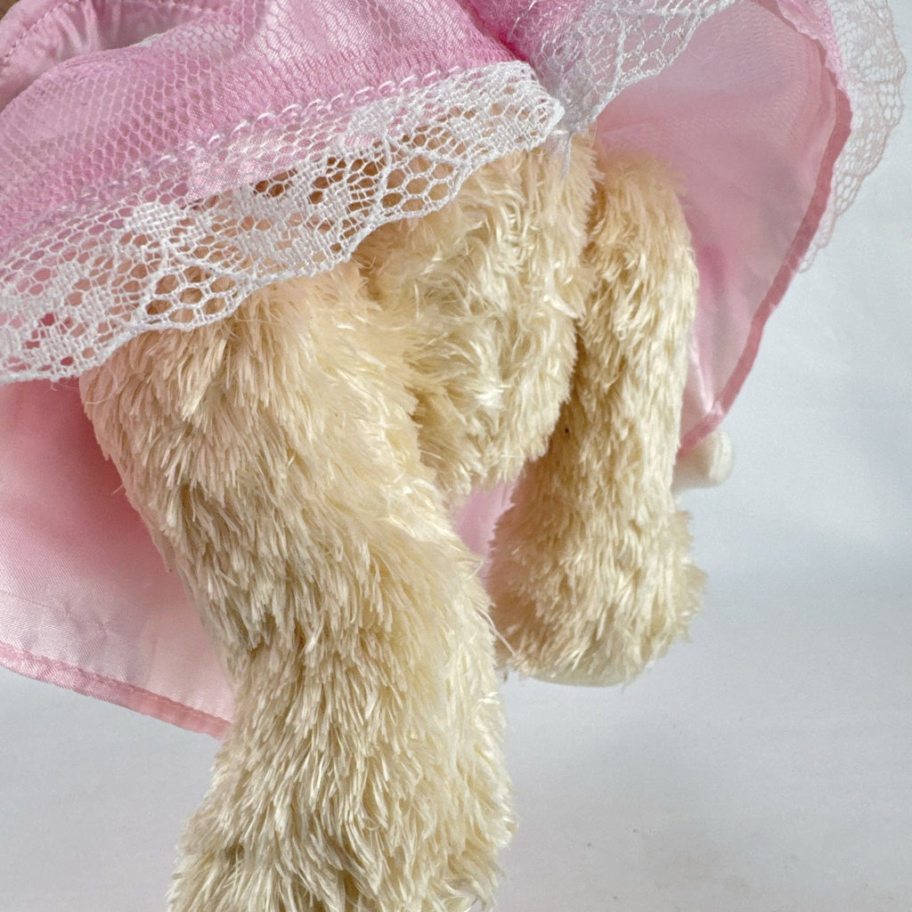 Oitscute 9-inch beige plush teddy bear wearing a pink lace dress and bonnet while holding a mini white bunny