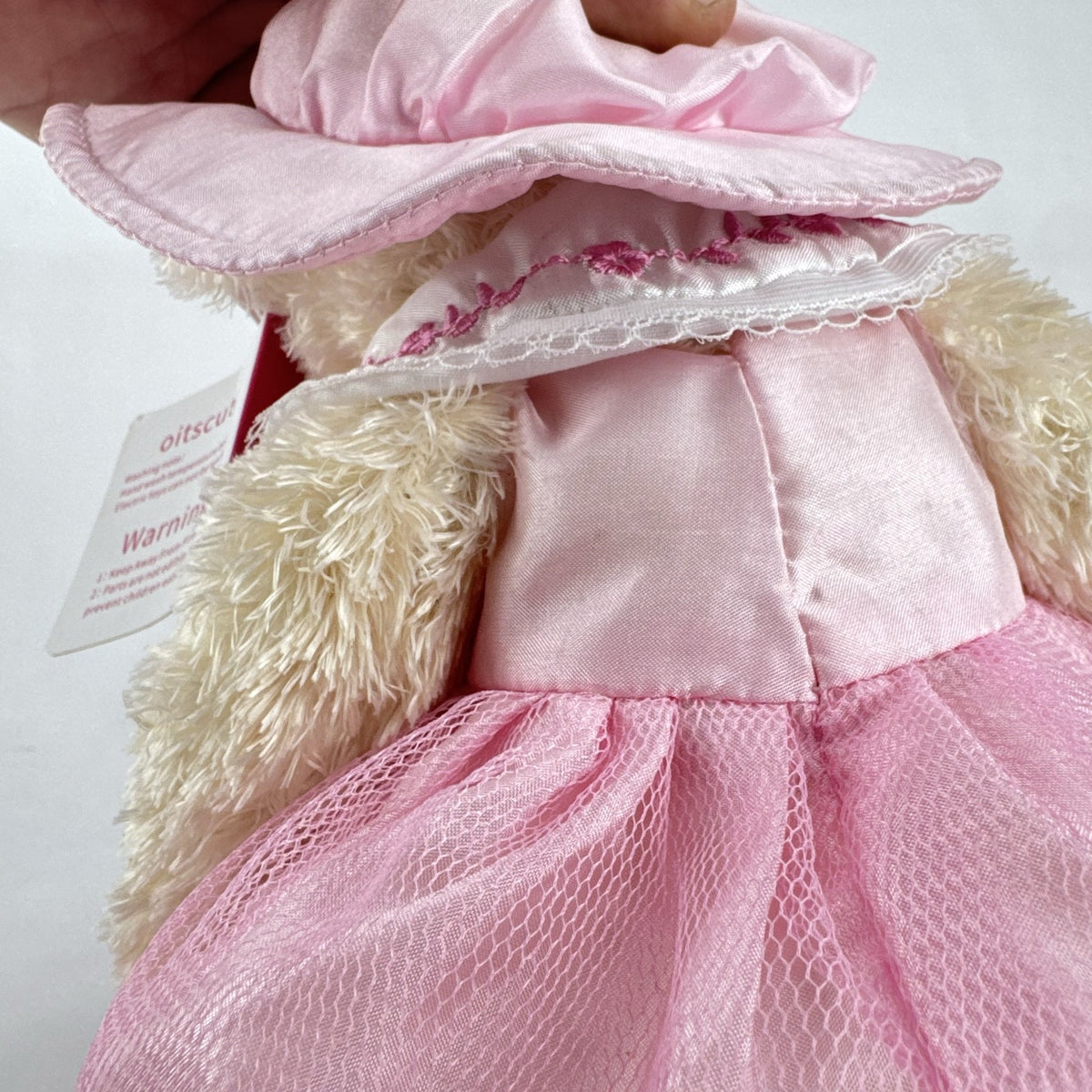 Oitscute 9-inch beige plush teddy bear wearing a pink lace dress and bonnet while holding a mini white bunny