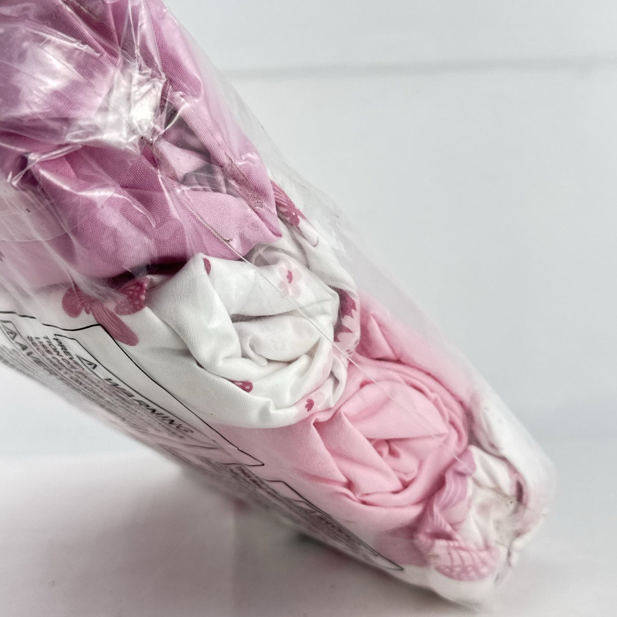 The Peanutshell 4-pack pink floral and butterfly microfiber fitted crib sheets in original packaging
