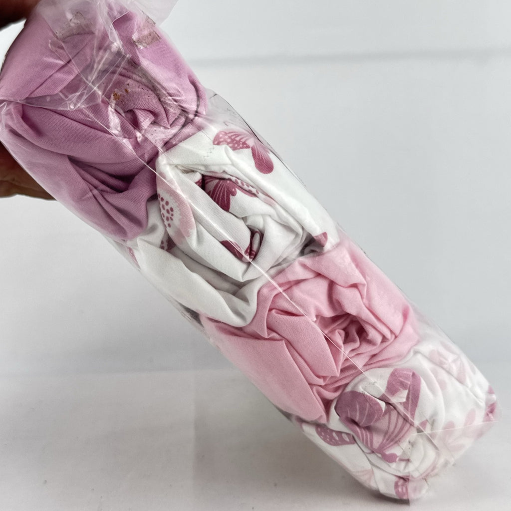 The Peanutshell 4-pack pink floral and butterfly microfiber fitted crib sheets in original packaging