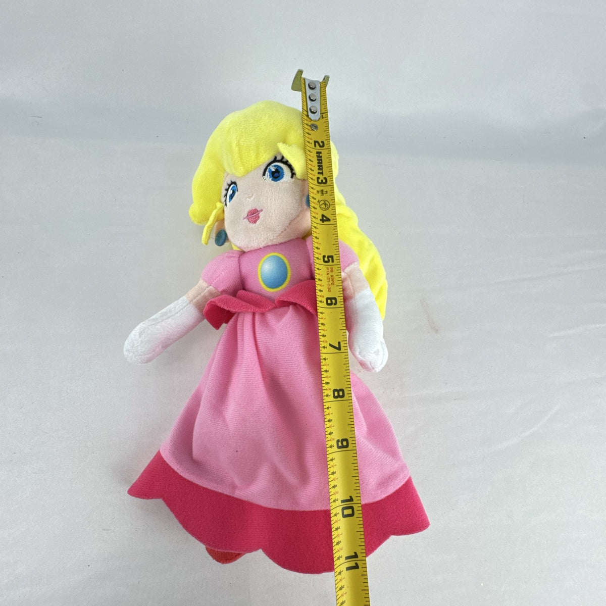 Nintendo Super Mario Princess Peach 11-inch plush doll wearing pink dress and crown