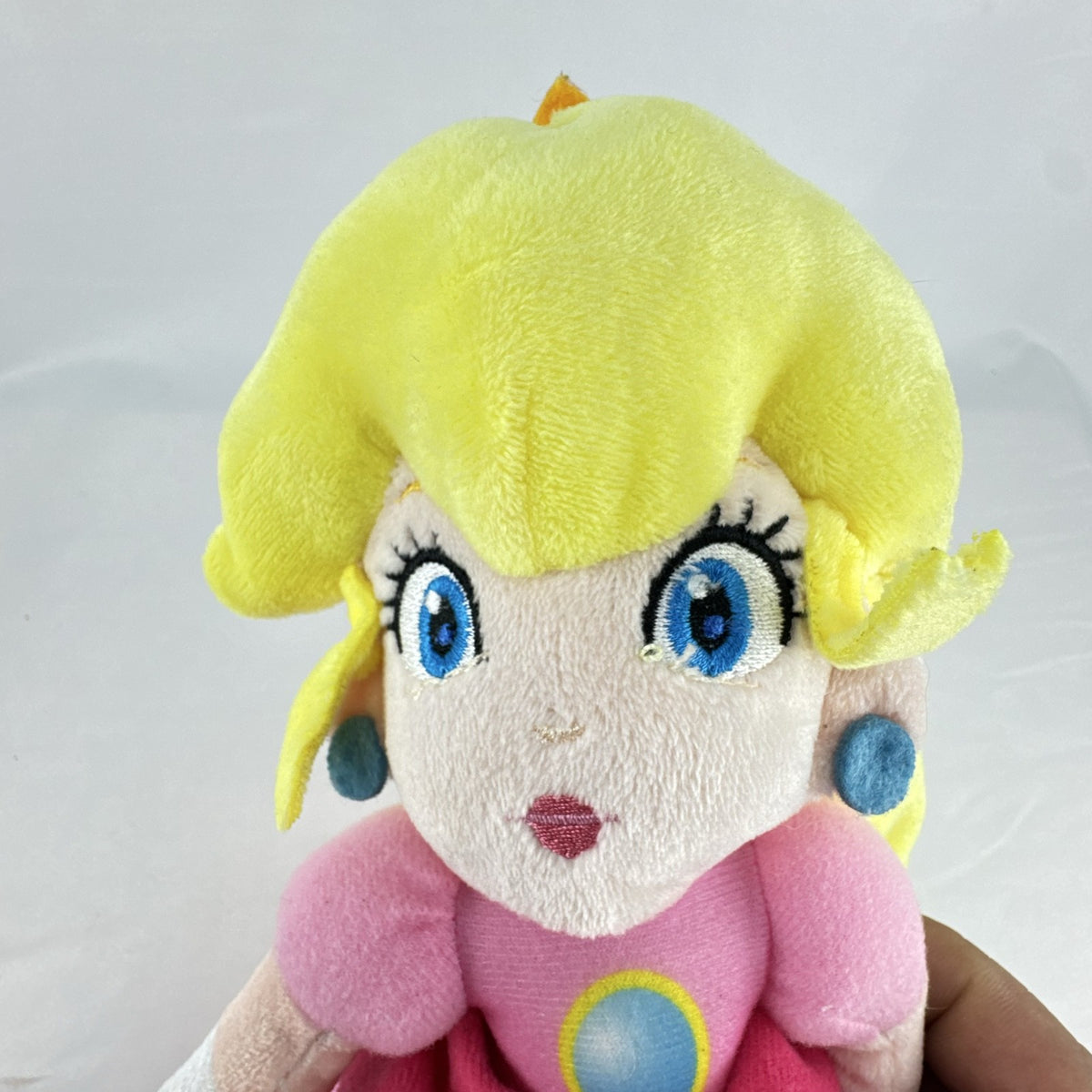 Nintendo Super Mario Princess Peach 11-inch plush doll wearing pink dress and crown