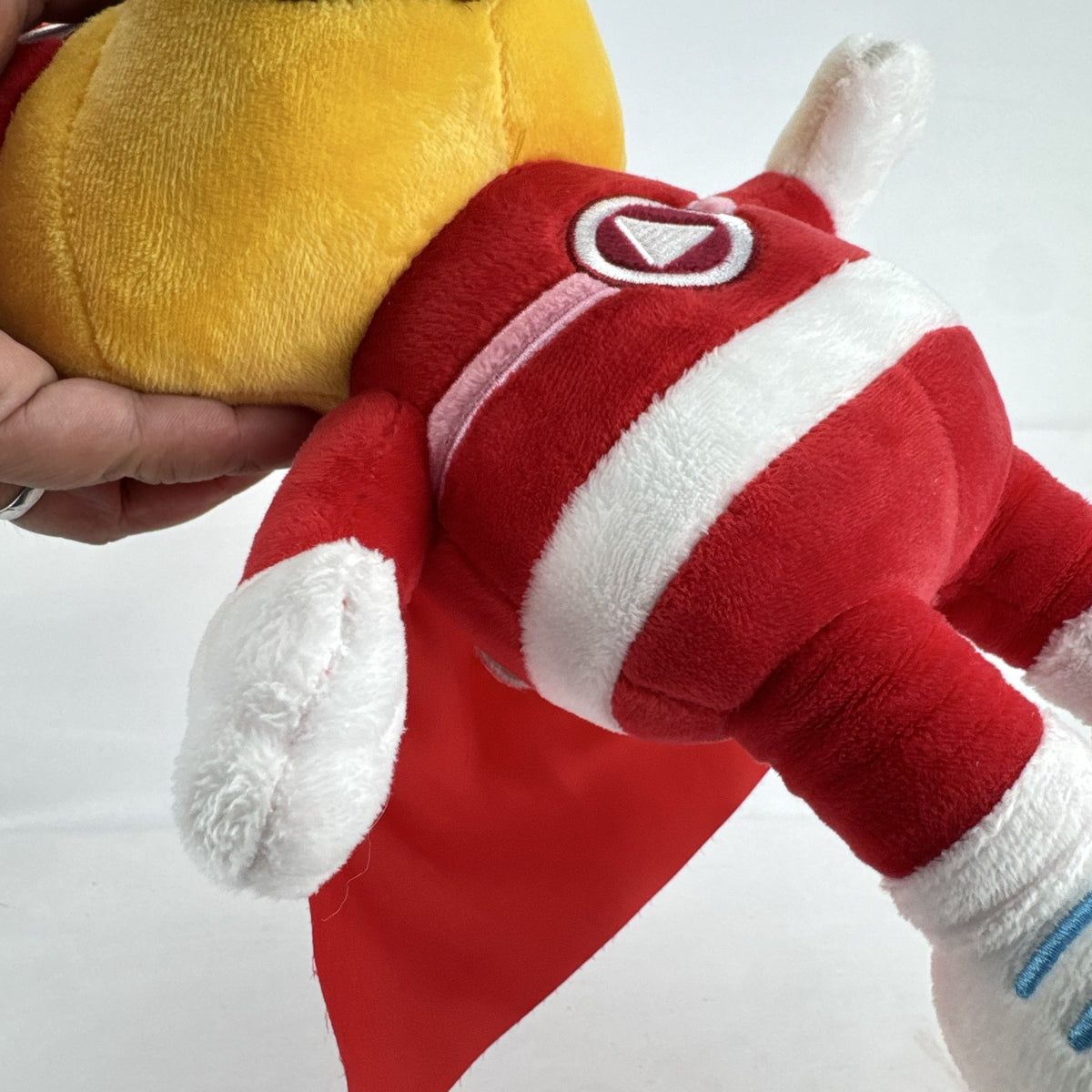 Kiddopia 12-inch yellow superhero dog plush toy wearing a red satin cape and embroidered eye mask.