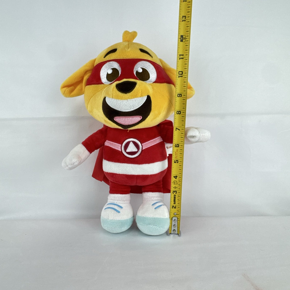 Kiddopia 12-inch yellow superhero dog plush toy wearing a red satin cape and embroidered eye mask.