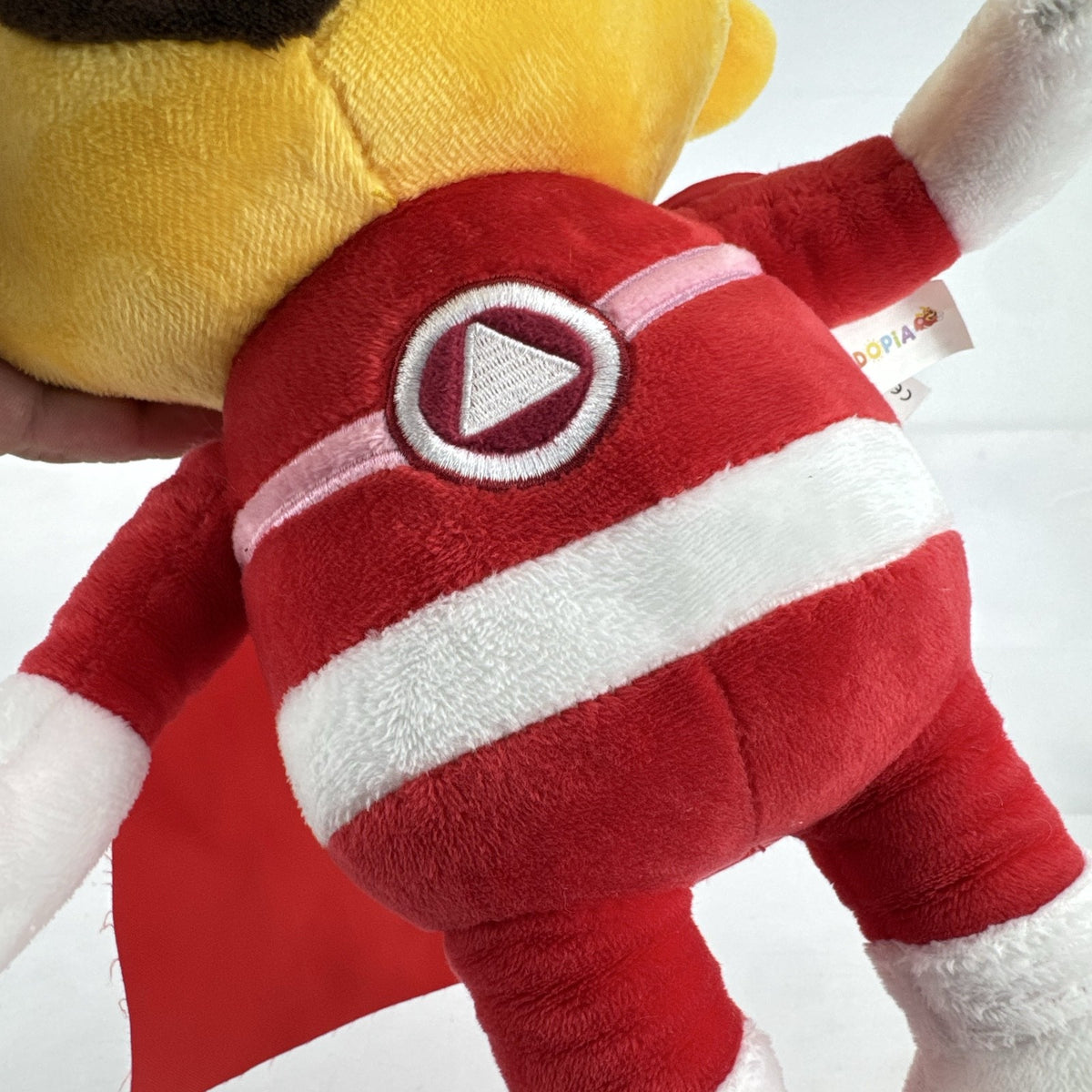 Kiddopia 12-inch yellow superhero dog plush toy wearing a red satin cape and embroidered eye mask.