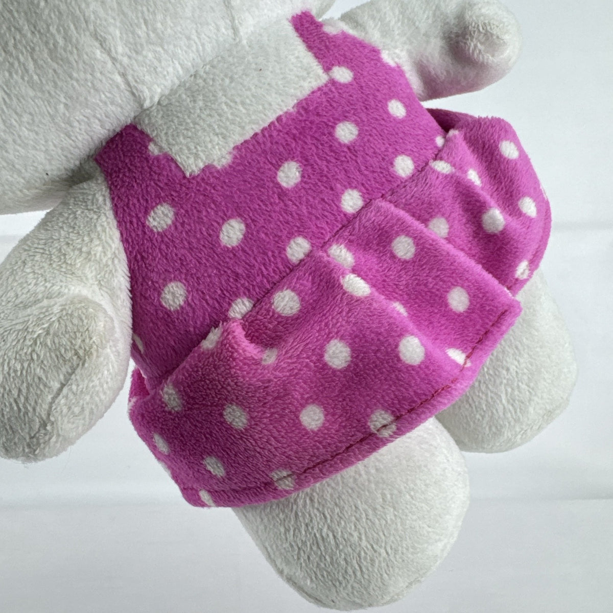 Sanrio 11-inch Hello Kitty plush wearing a pink polka dot dress with a purple flower