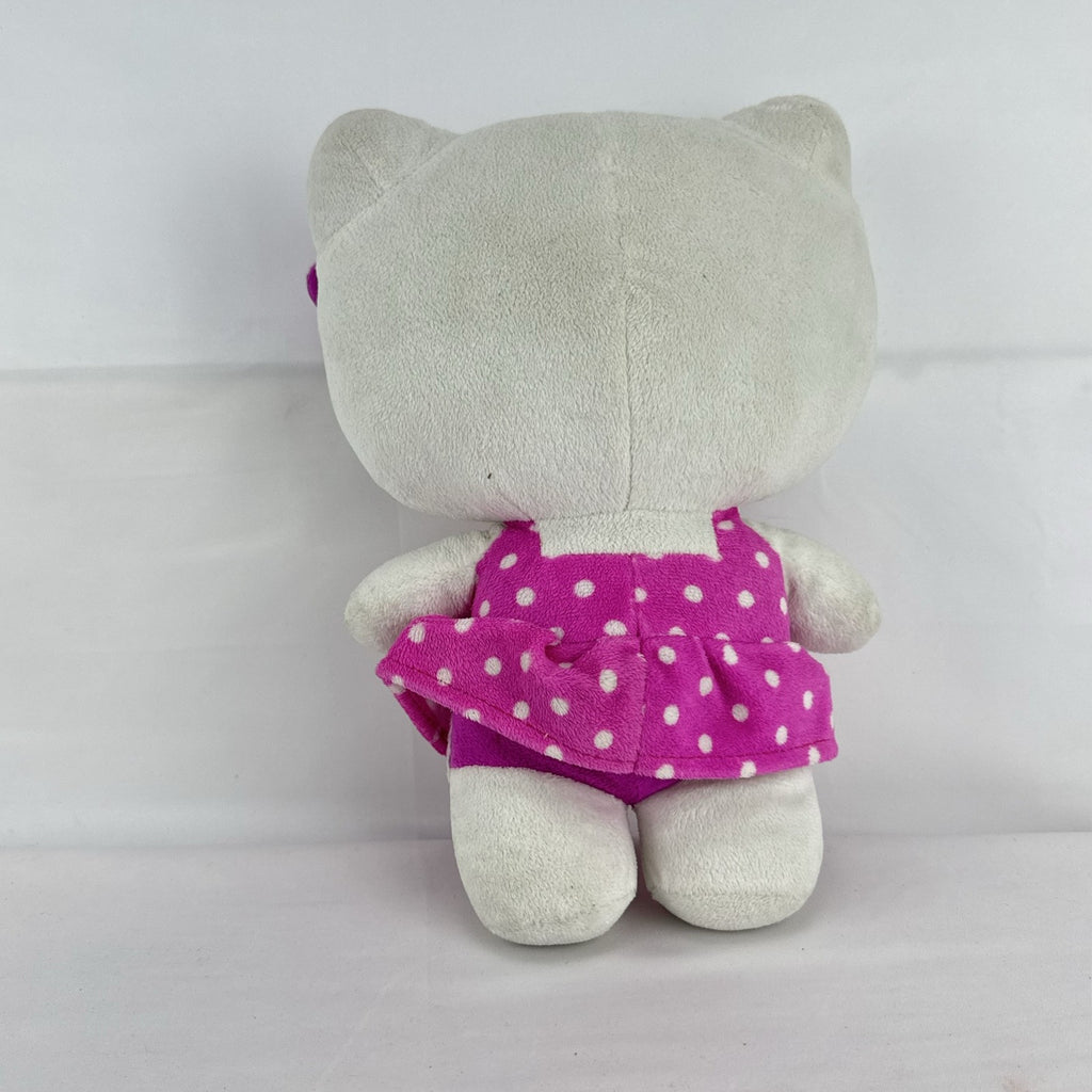 Sanrio 11-inch Hello Kitty plush wearing a pink polka dot dress with a purple flower