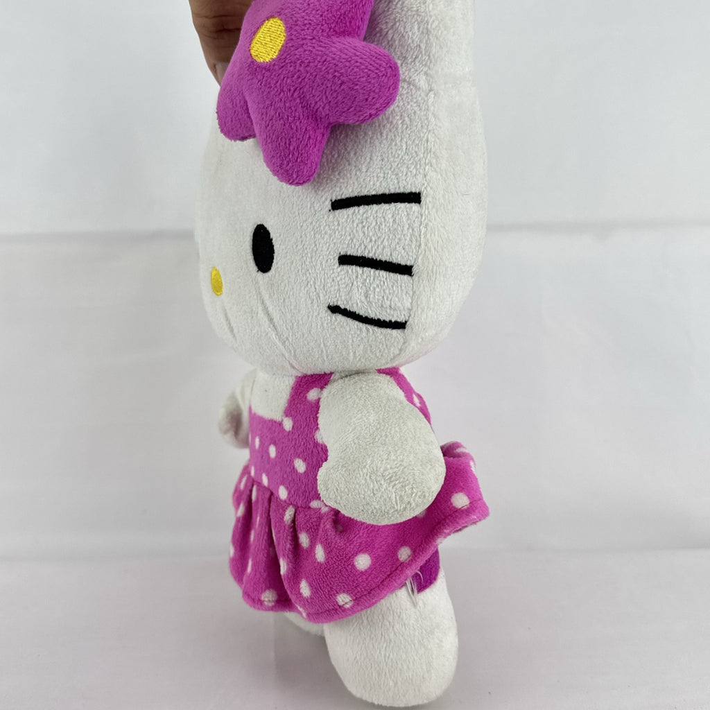 Sanrio 11-inch Hello Kitty plush wearing a pink polka dot dress with a purple flower