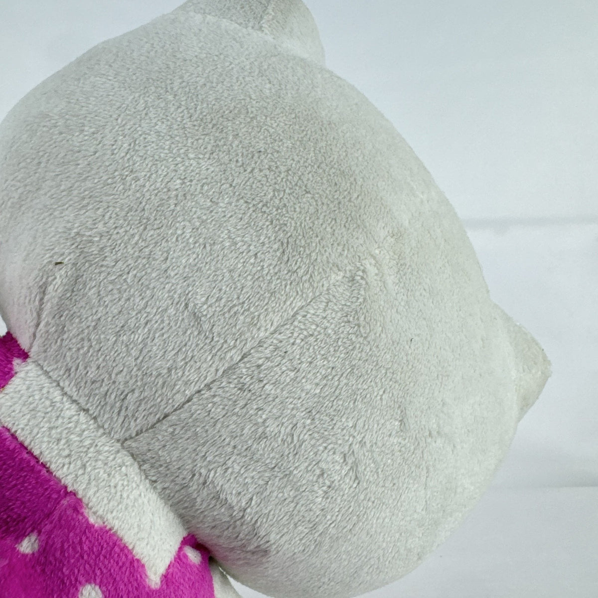Sanrio 11-inch Hello Kitty plush wearing a pink polka dot dress with a purple flower
