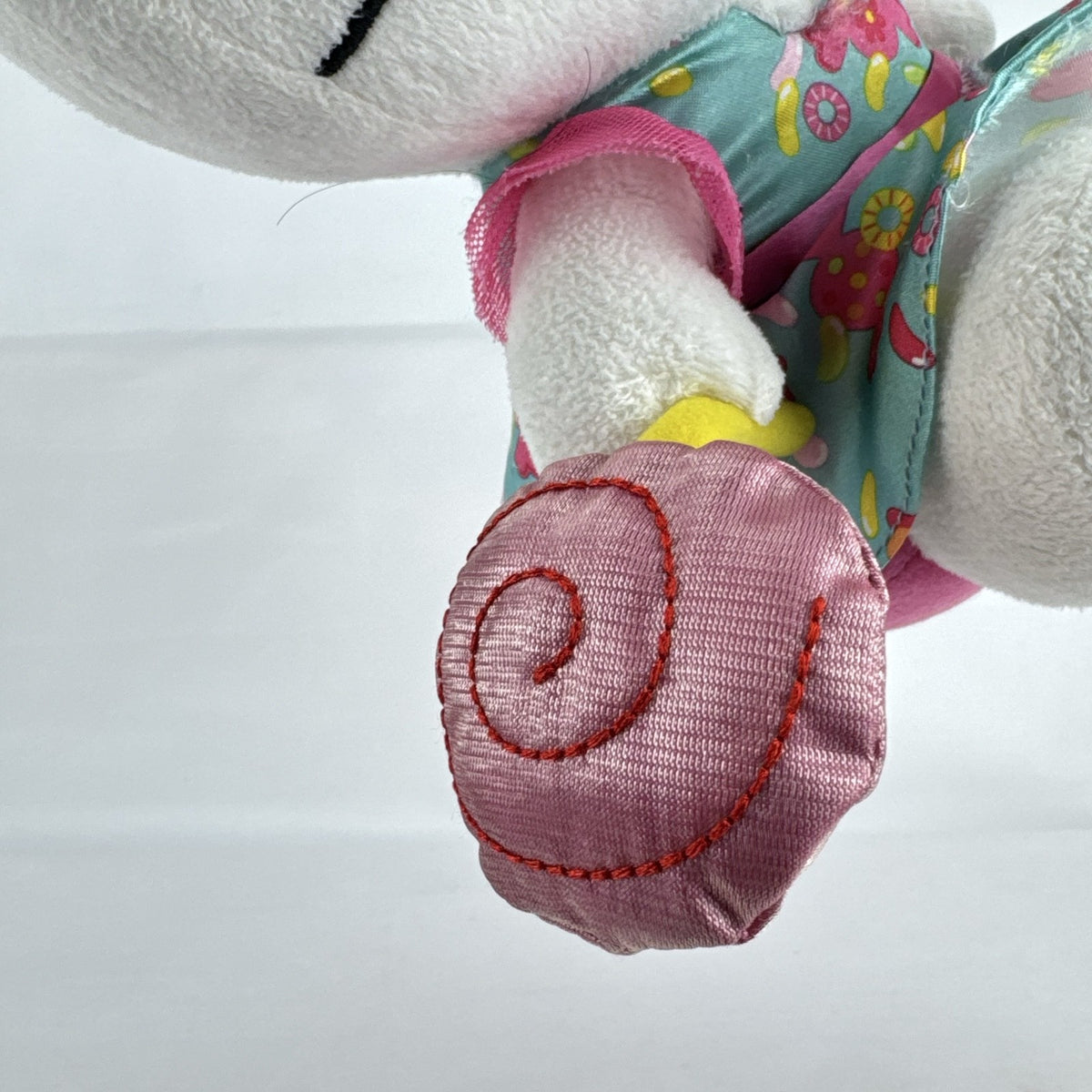 Sanrio Hello Kitty 9-inch plush doll wearing a teal candy print satin dress and holding a pink swirl lollipop.