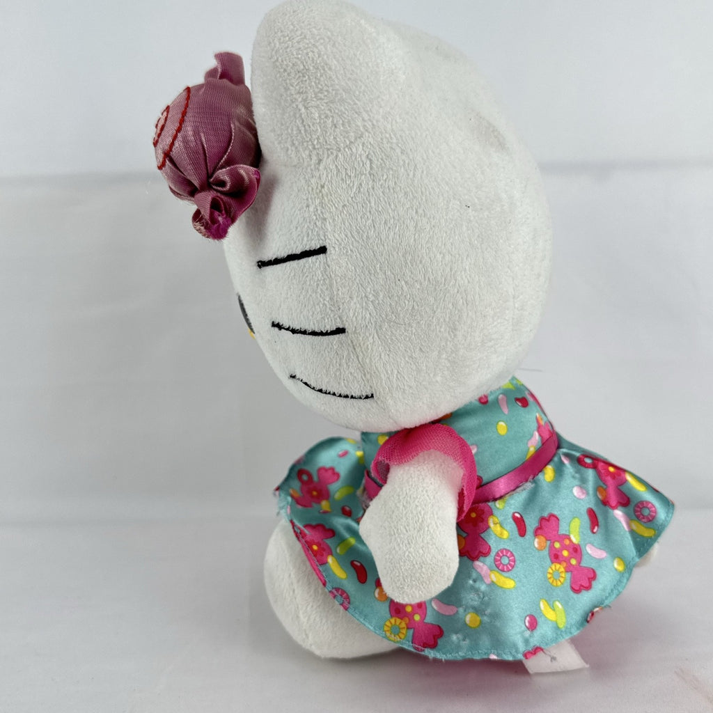 Sanrio Hello Kitty 9-inch plush doll wearing a teal candy print satin dress and holding a pink swirl lollipop.