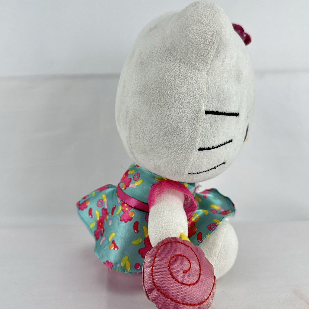 Sanrio Hello Kitty 9-inch plush doll wearing a teal candy print satin dress and holding a pink swirl lollipop.