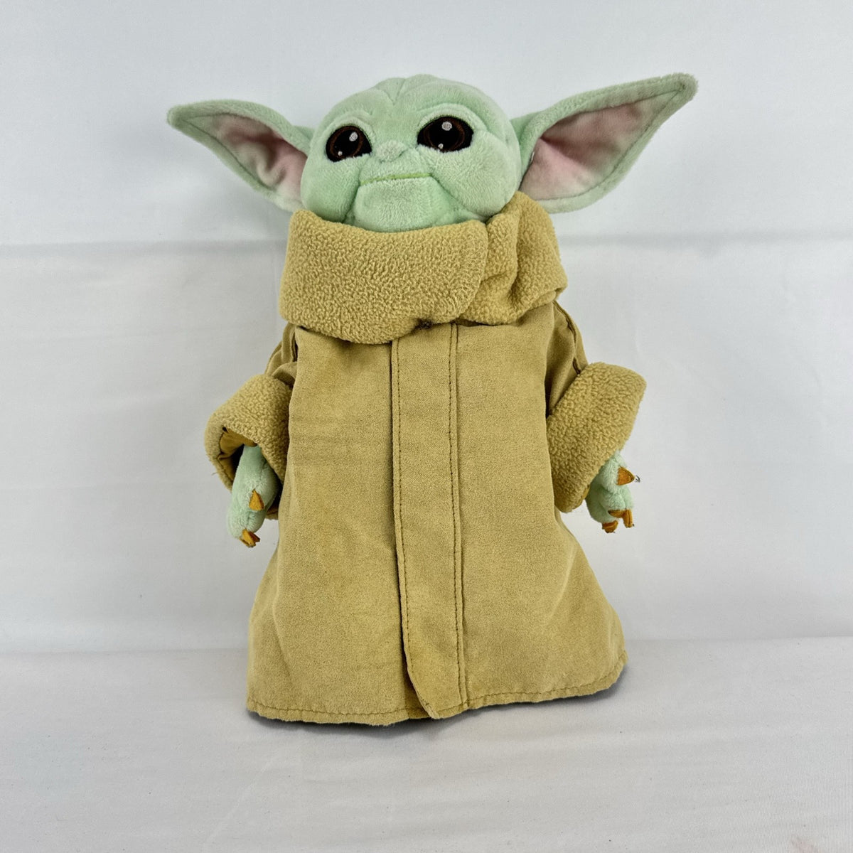 Disney Store 11-inch Grogu plush doll wearing a tan faux-suede coat with fleece trim