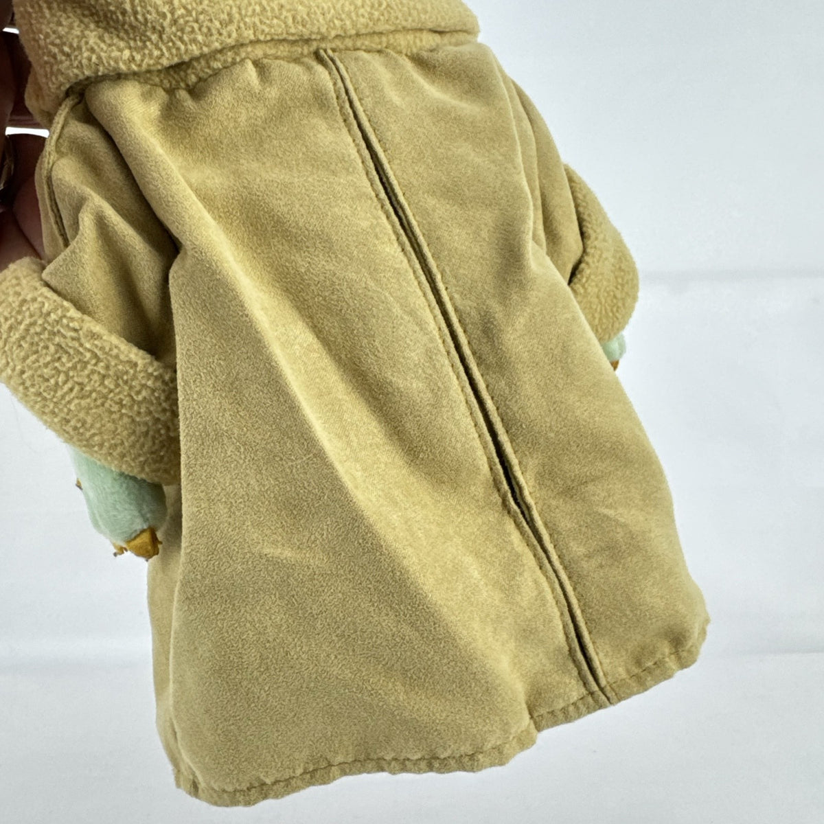 Disney Store 11-inch Grogu plush doll wearing a tan faux-suede coat with fleece trim