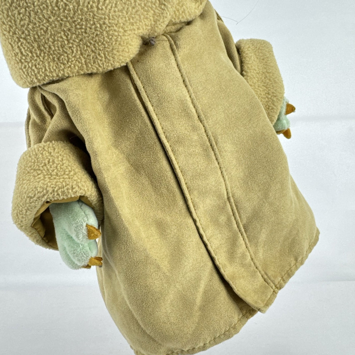 Disney Store 11-inch Grogu plush doll wearing a tan faux-suede coat with fleece trim