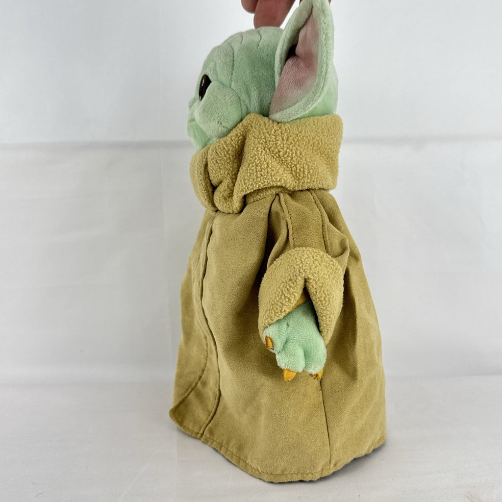 Disney Store 11-inch Grogu plush doll wearing a tan faux-suede coat with fleece trim