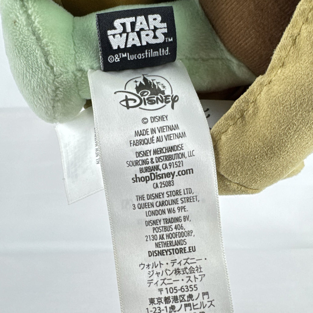 Disney Store 11-inch Grogu plush doll wearing a tan faux-suede coat with fleece trim