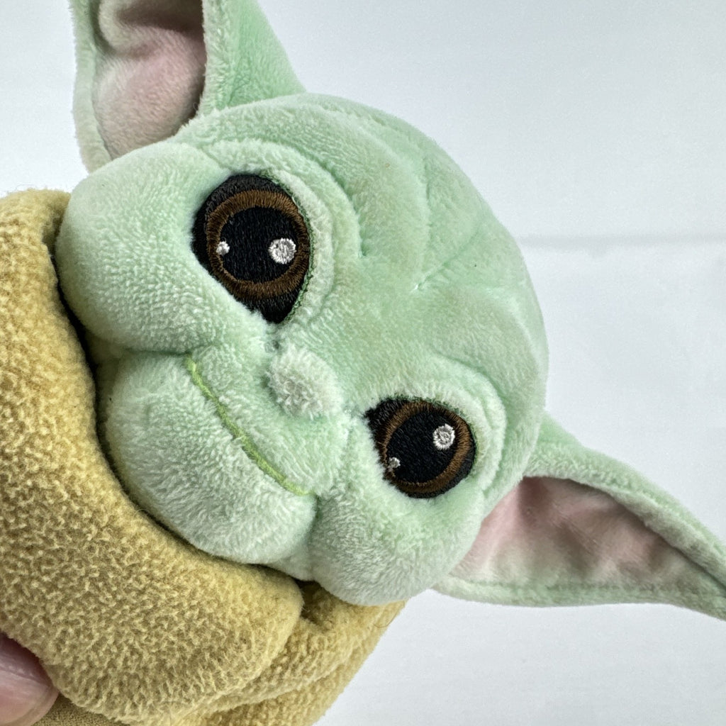 Disney Store 11-inch Grogu plush doll wearing a tan faux-suede coat with fleece trim