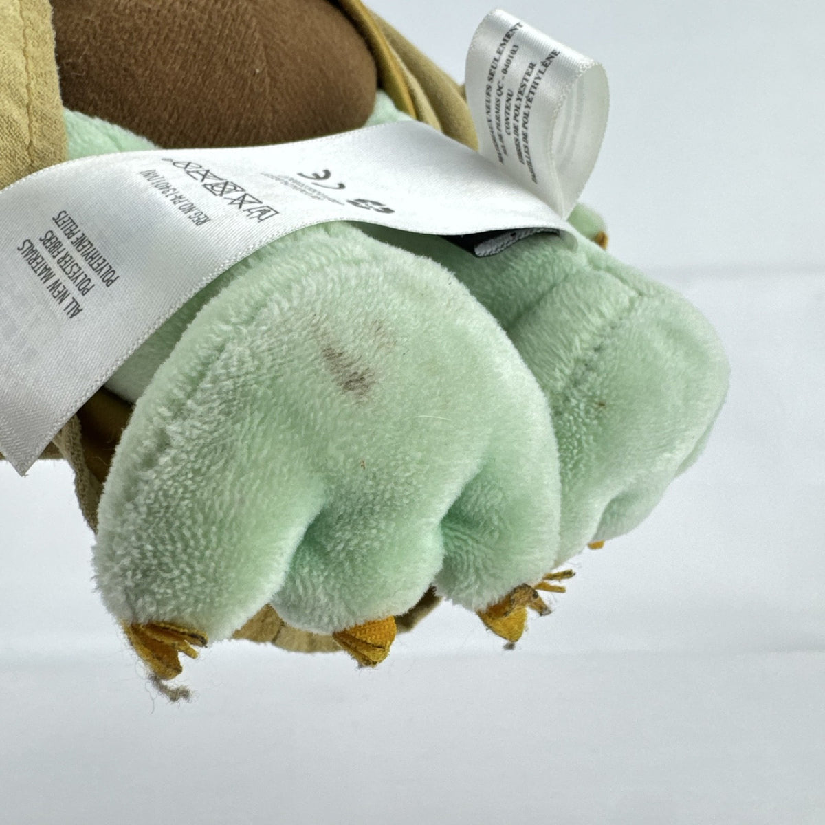 Disney Store 11-inch Grogu plush doll wearing a tan faux-suede coat with fleece trim