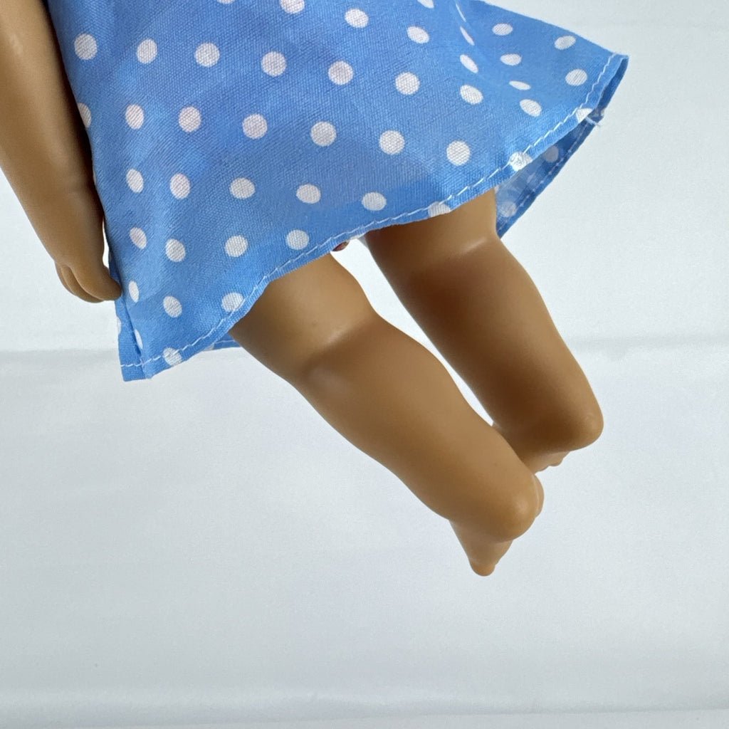 Hasbro Baby Alive 11-inch vinyl baby doll with molded brown hair, brown eyes, and blue polka dot dress