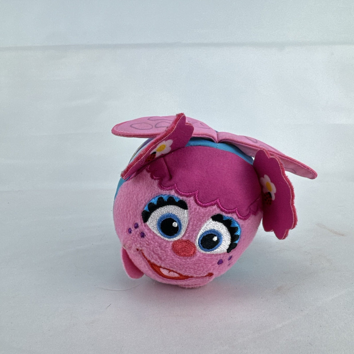 Sesame Street 50th Anniversary Abby Cadabby fairy roll plush stuffed toy with wings and floral pattern