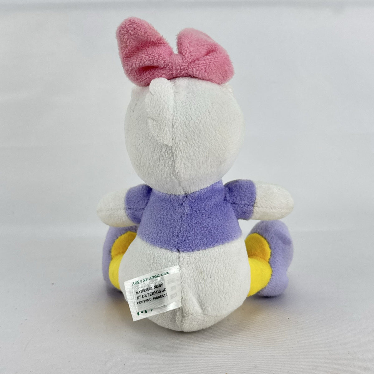 Kids Preferred Disney Baby Daisy Duck seated plush in purple outfit with pink bow