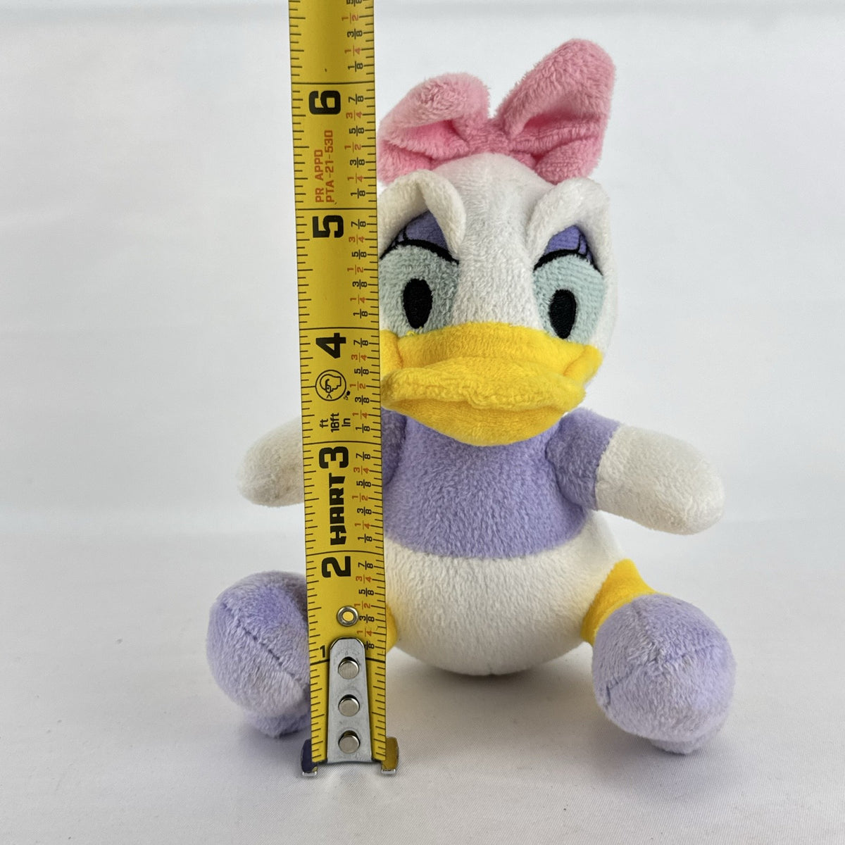 Kids Preferred Disney Baby Daisy Duck seated plush in purple outfit with pink bow