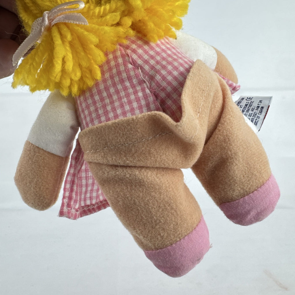 Mary Meyer 7-inch plush rag doll with yellow yarn pigtails and pink gingham dress