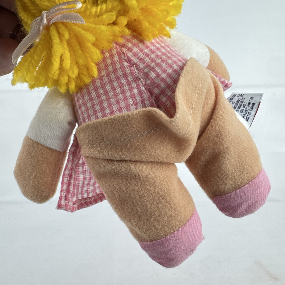 Mary Meyer 7-inch plush rag doll with yellow yarn pigtails and pink gingham dress