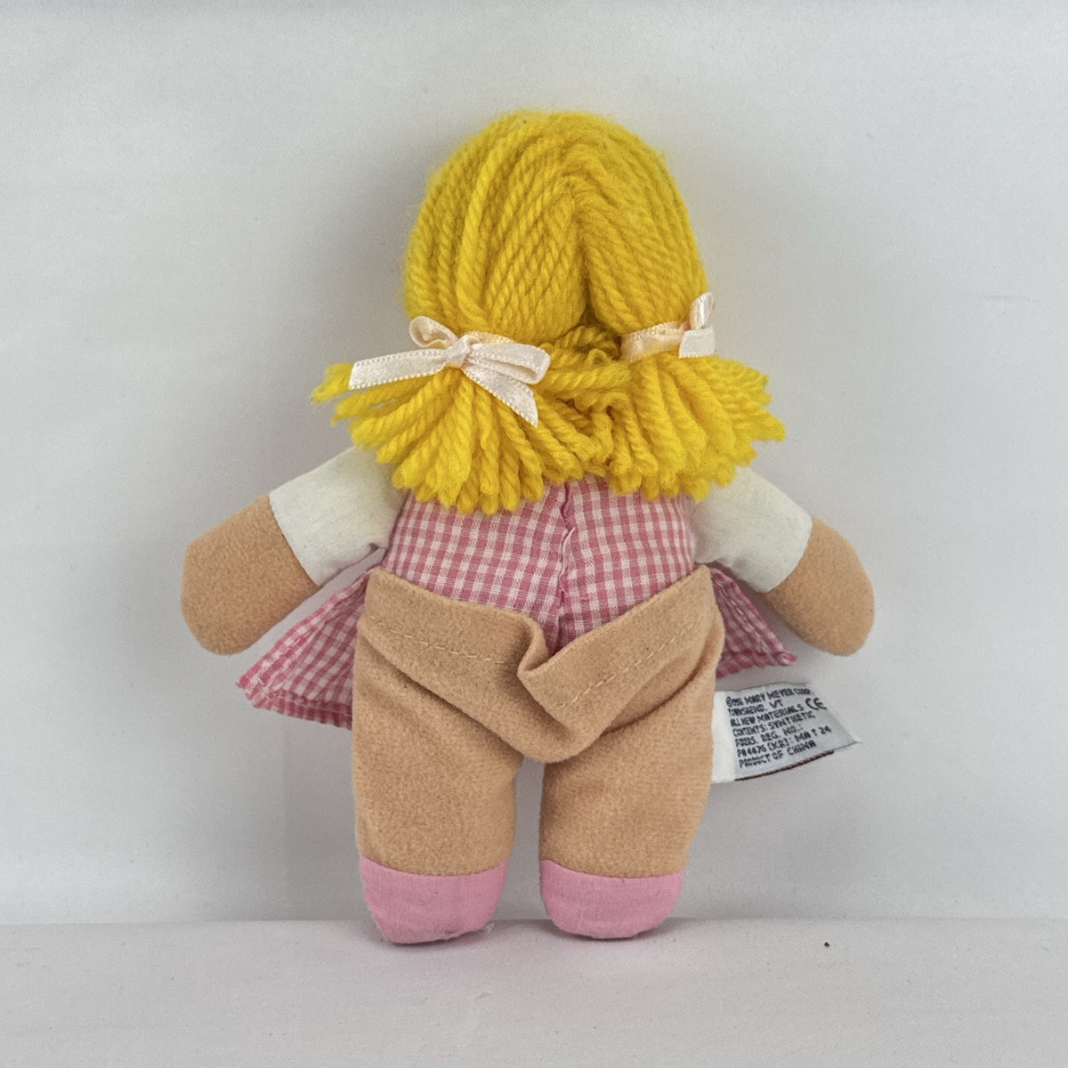 Mary Meyer 7-inch plush rag doll with yellow yarn pigtails and pink gingham dress