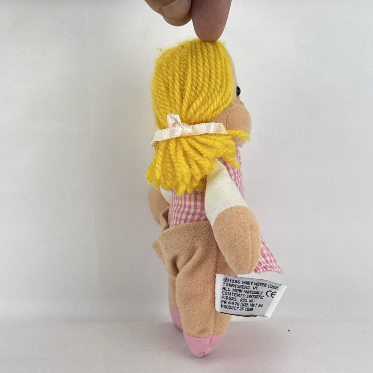 Mary Meyer 7-inch plush rag doll with yellow yarn pigtails and pink gingham dress
