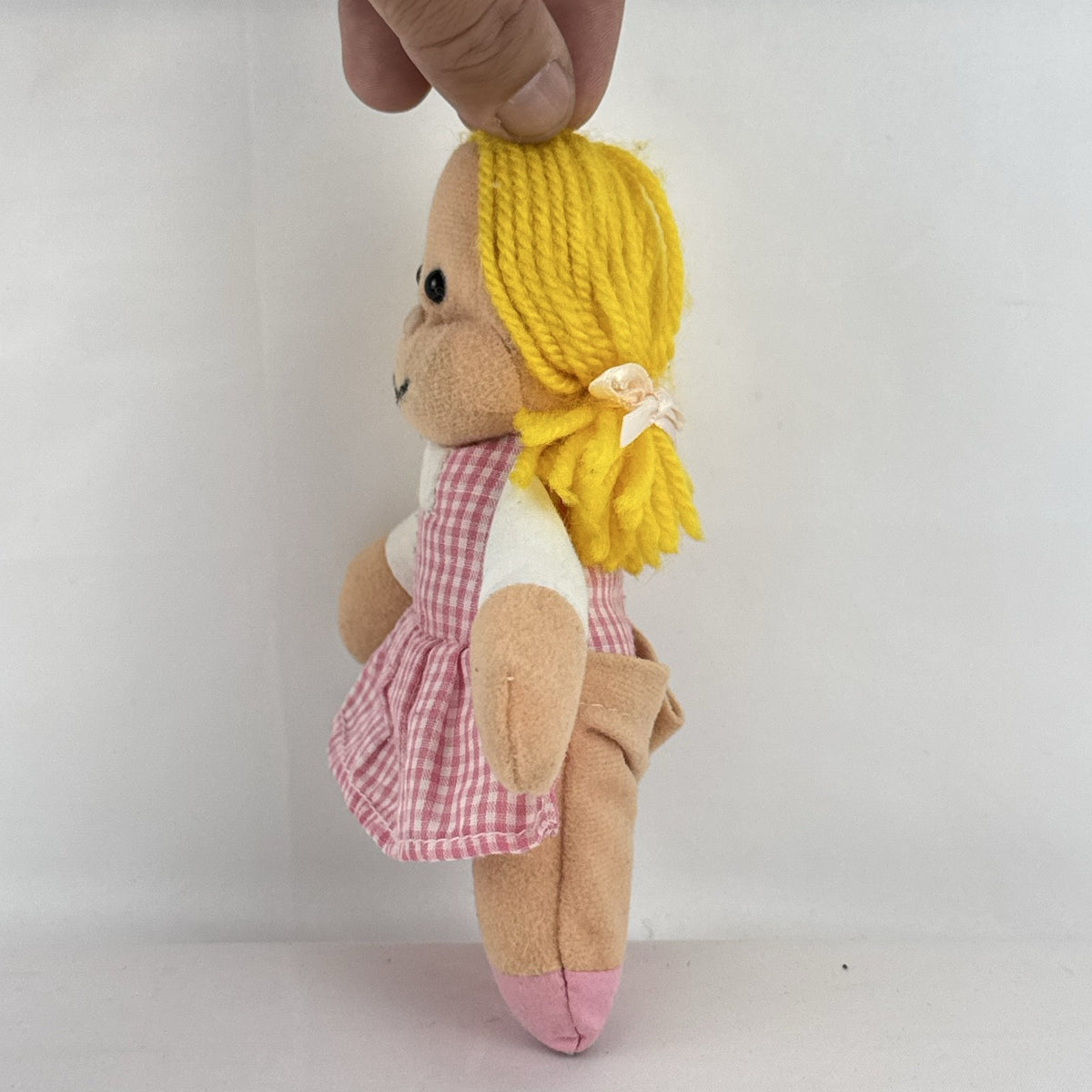 Mary Meyer 7-inch plush rag doll with yellow yarn pigtails and pink gingham dress