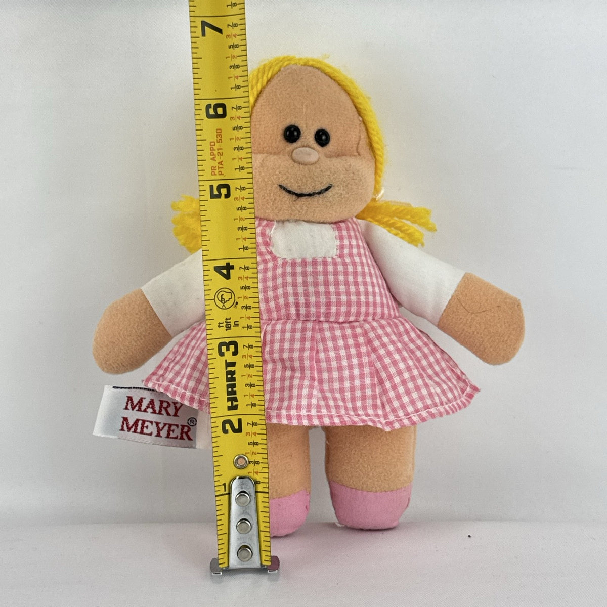 Mary Meyer 7-inch plush rag doll with yellow yarn pigtails and pink gingham dress