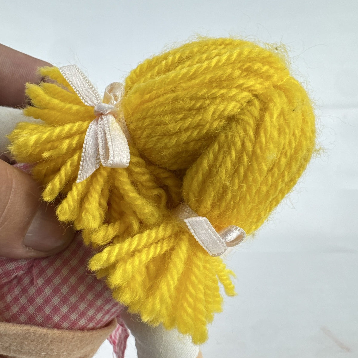 Mary Meyer 7-inch plush rag doll with yellow yarn pigtails and pink gingham dress