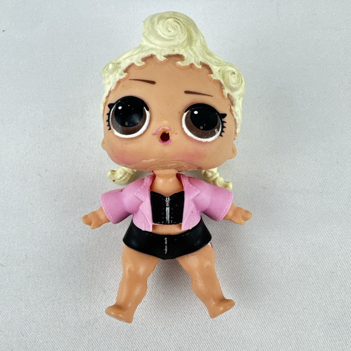 MGA L.O.L. Surprise! Biker Babe 3-inch doll with blonde sculpted hair, pink moto jacket, and MOM heart tattoo