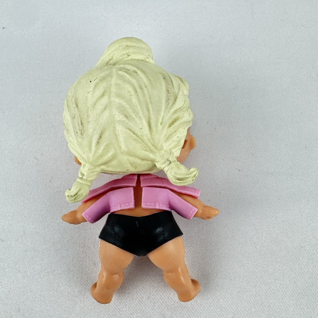 MGA L.O.L. Surprise! Biker Babe 3-inch doll with blonde sculpted hair, pink moto jacket, and MOM heart tattoo