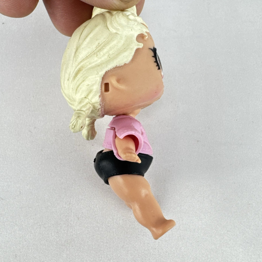 MGA L.O.L. Surprise! Biker Babe 3-inch doll with blonde sculpted hair, pink moto jacket, and MOM heart tattoo
