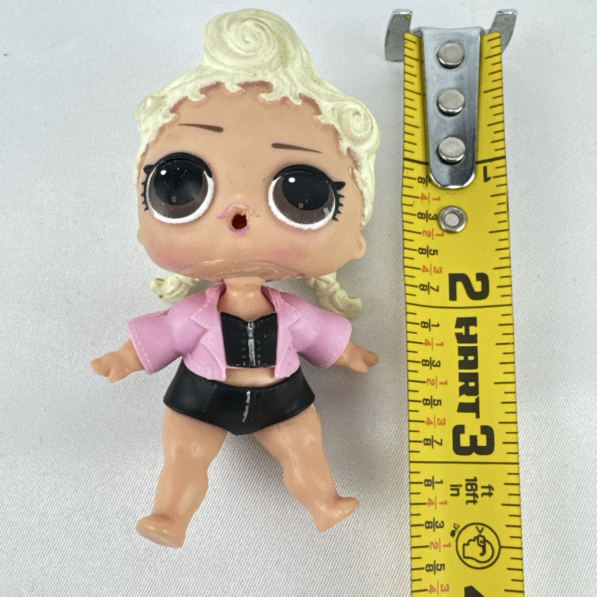 MGA L.O.L. Surprise! Biker Babe 3-inch doll with blonde sculpted hair, pink moto jacket, and MOM heart tattoo