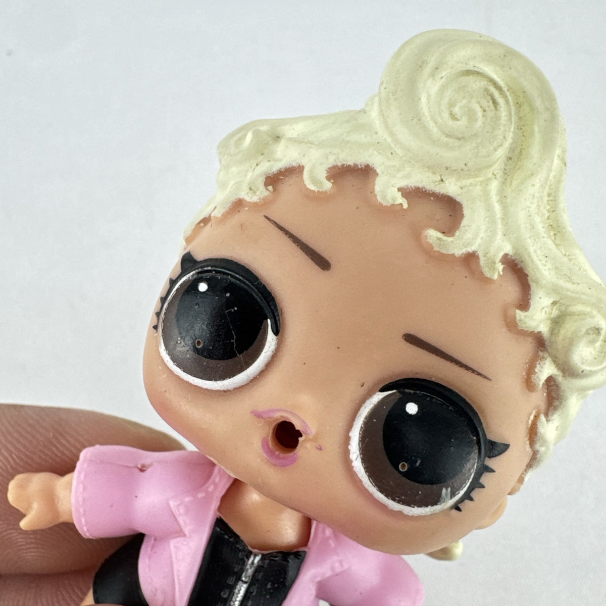 MGA L.O.L. Surprise! Biker Babe 3-inch doll with blonde sculpted hair, pink moto jacket, and MOM heart tattoo